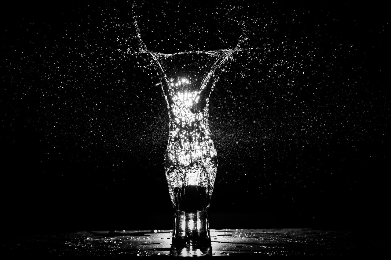 A captivating black and white long exposure shot of a water splash in a glass.